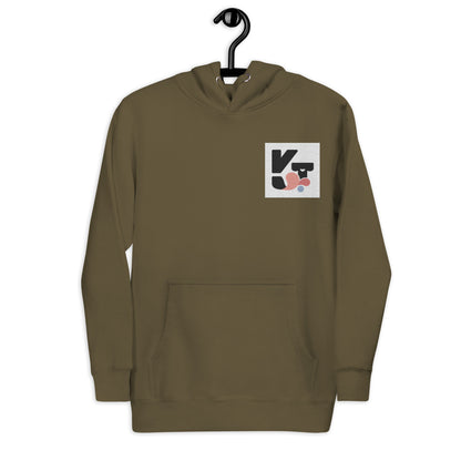 Unisex-Kapuzenpullover "Shake it" in Olivgrün von Klexgetier. Der Pullover zeigt ein modernes grafisches Logo-Symbol in Schwarz, Grau und Rosa auf der Vorderseite.