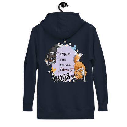 Unisex-Kapuzenpullover mit grafischer Hundemotiv-Gestaltung. Der Kapuzenpullover zeigt verschiedene Hunderassen wie Shelties umgeben von Blumen und Sternen. Der Schriftzug "ENJOY THE SMALL THINGS DOGS" ist prominent platziert. Das Produkt ist in einem eleganten Dunkelblau gehalten und wurde vom deutschen Markenunternehmen Klexgetier entworfen, das sich auf personalisierte Sportbekleidung und Accessoires für Hundehalter spezialisiert hat.